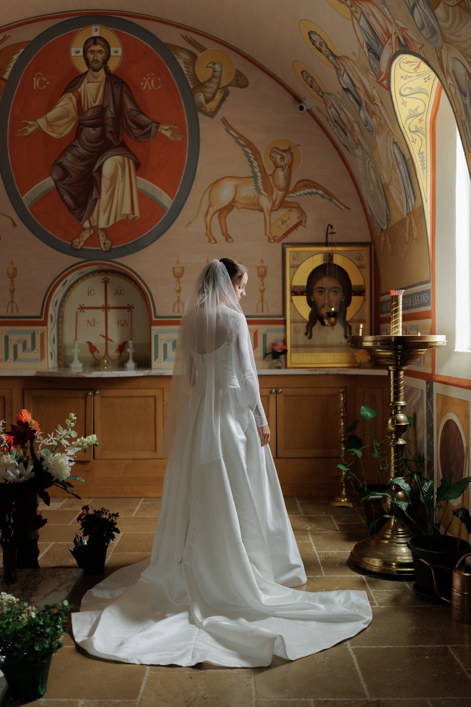 Bride before the iconostasis at an Orthodox Christian wedding